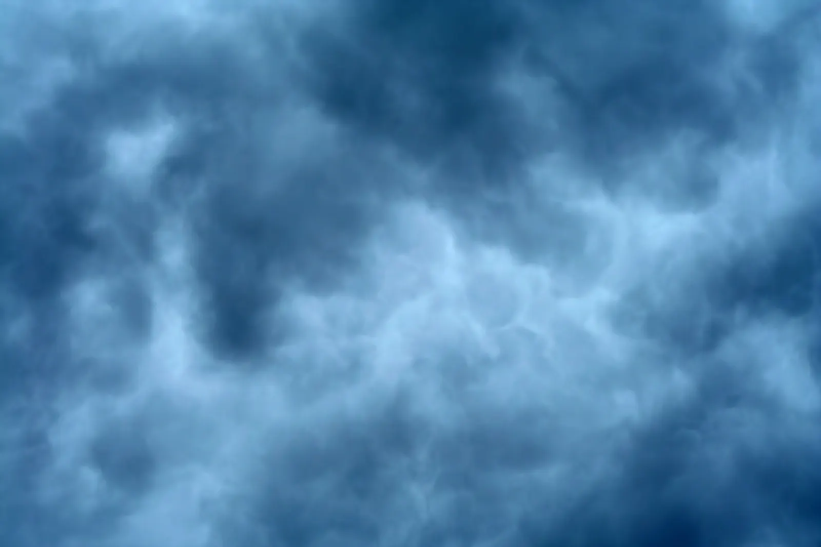 Dark blue storm clouds with soft billowing texture filling the frame