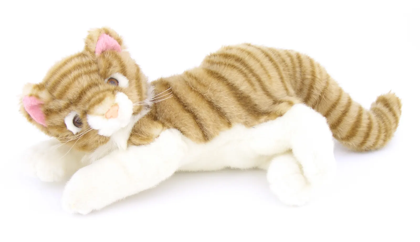 Plush ginger striped toy cat with white paws lying on a white background