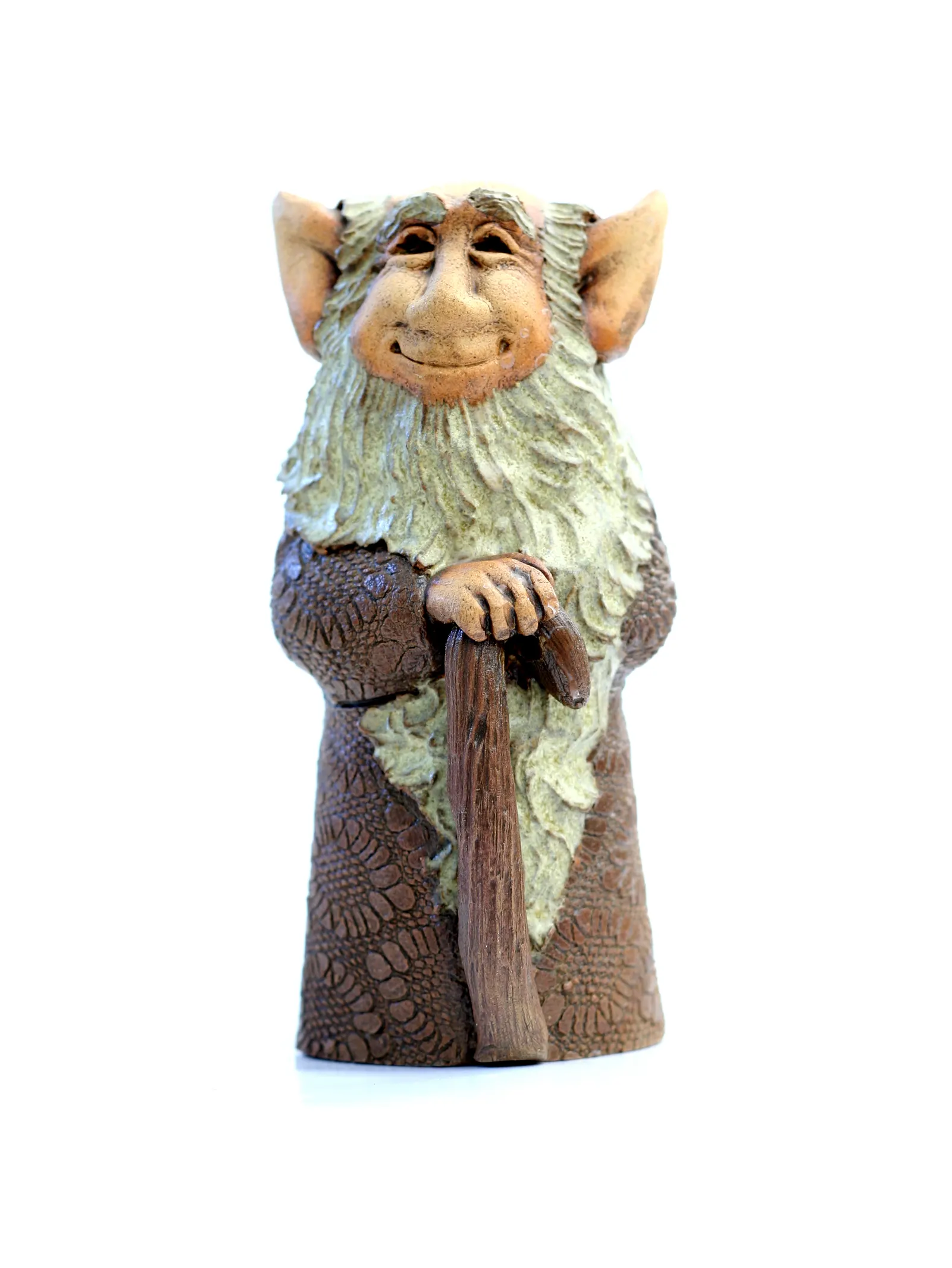 Clay figurine of a smiling bearded old man leaning on a staff on white