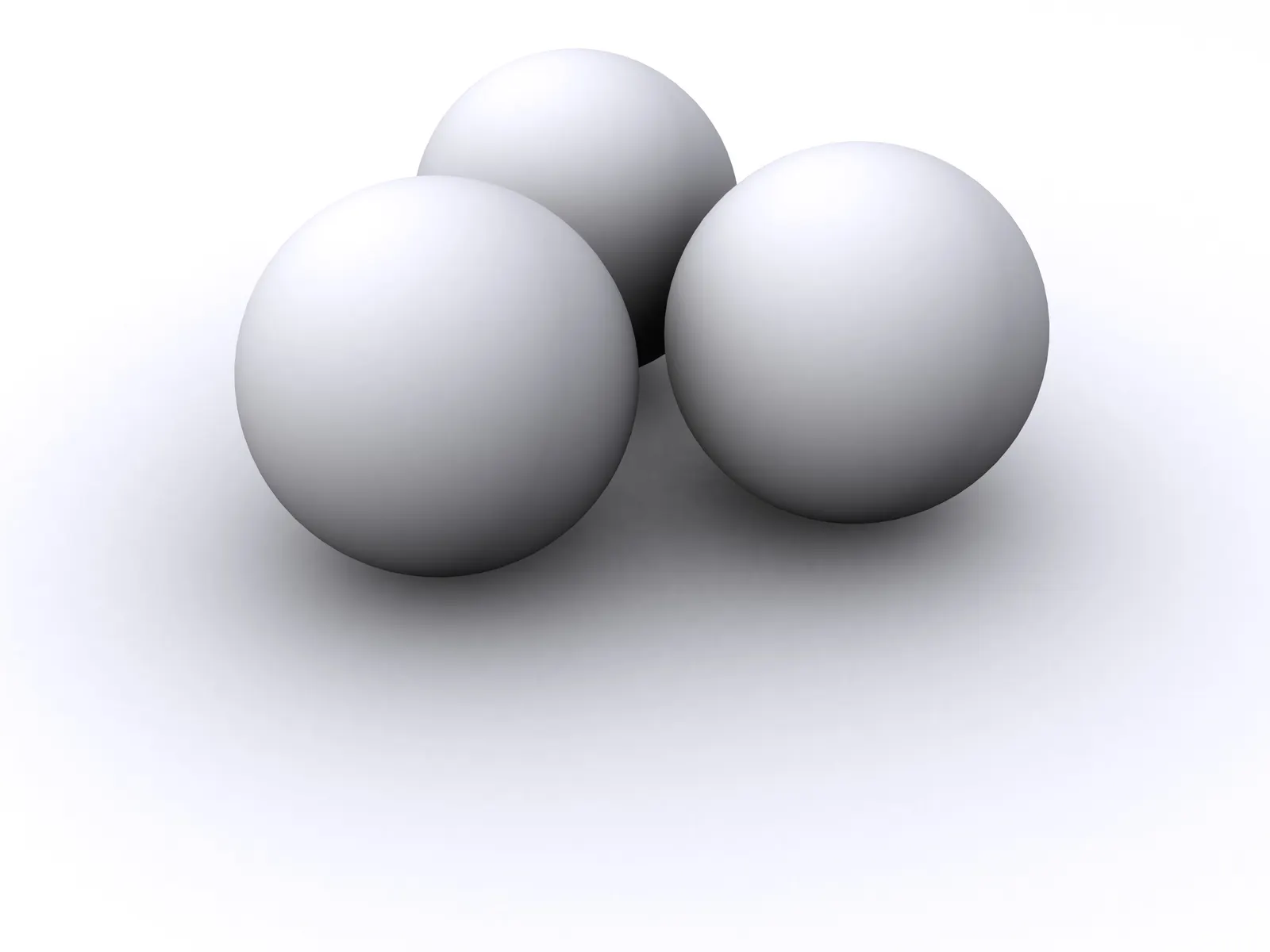 Three white 3D spheres grouped together on a white background with soft shadows
