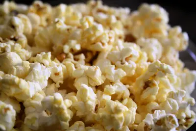 Close-up of a heap of buttery popcorn with shallow depth of field