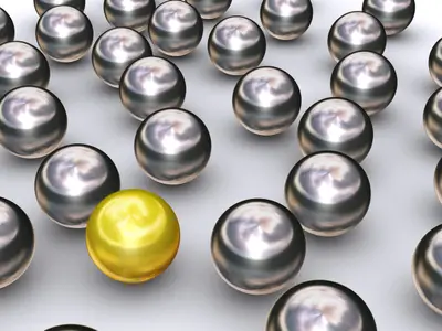 Single gold sphere among many shiny chrome spheres in a 3D render